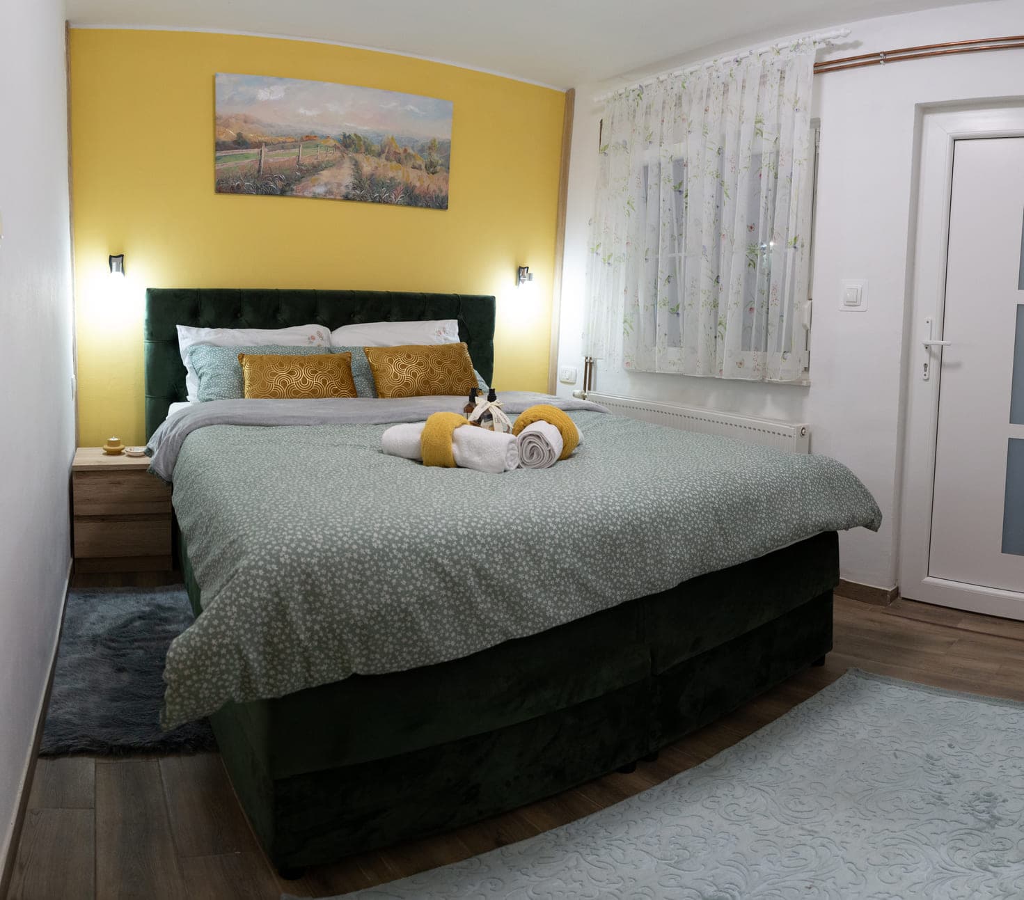 Warm and clean bedroom with king size bed, including extra pillows and sheets.