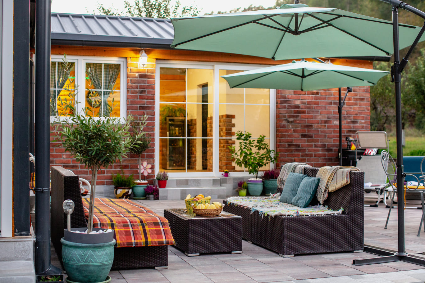 A cozy patio featuring a table surrounded by chairs, perfect for outdoor dining and relaxation.