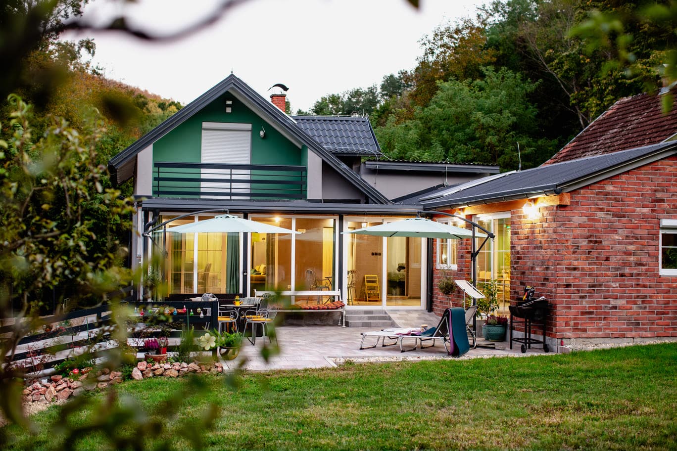 A cozy home nestled in a serene landscape filled with trees and flowers.